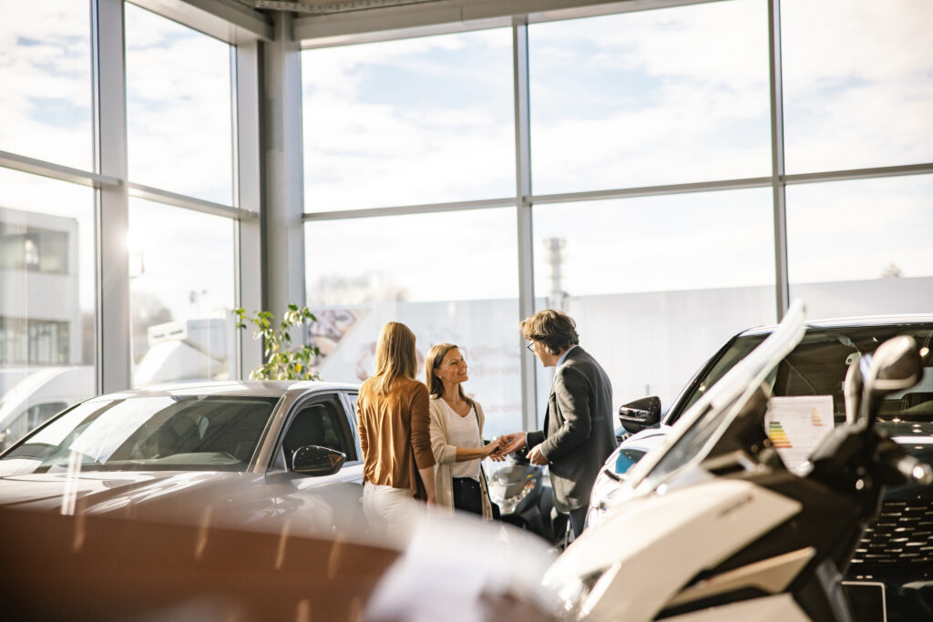 Family at dealership with sales associate
